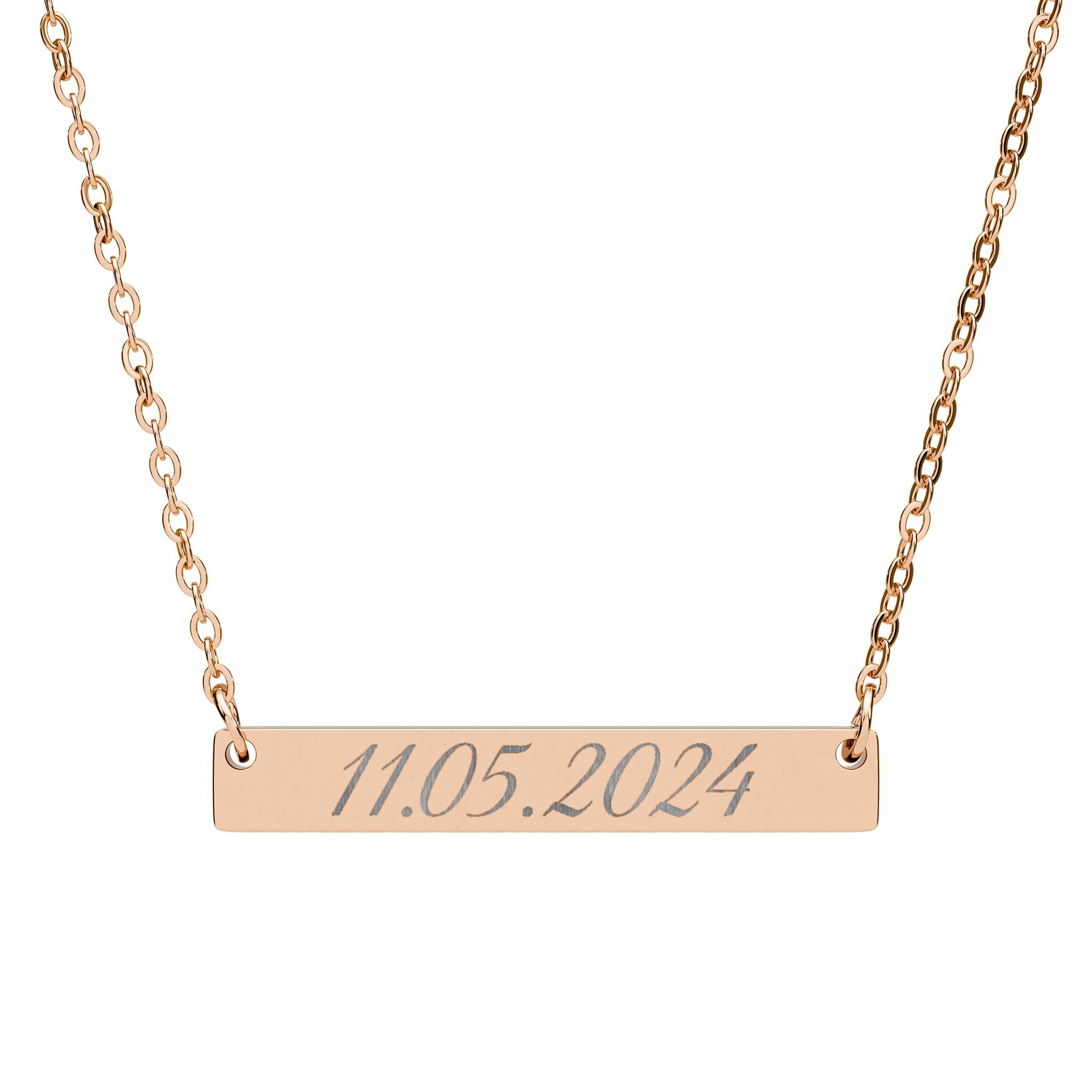 Rose gold necklace with a engraved date on a white background