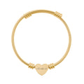 Gold bracelet with a heart-shaped tag on a white background