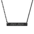 Black bar necklace with engraved date on a white background