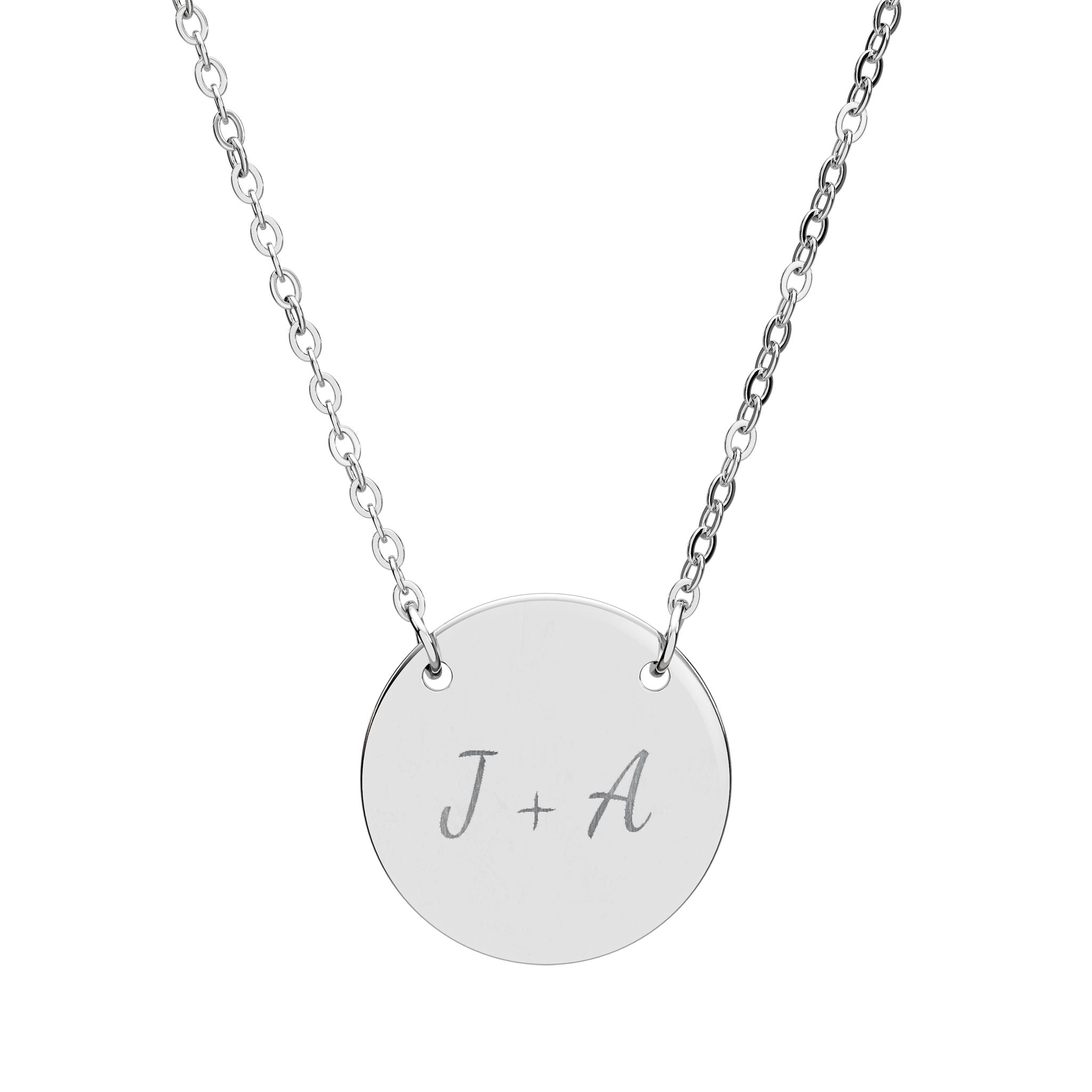 Silver necklace with a round pendant engraved with 'J + A' on a white background