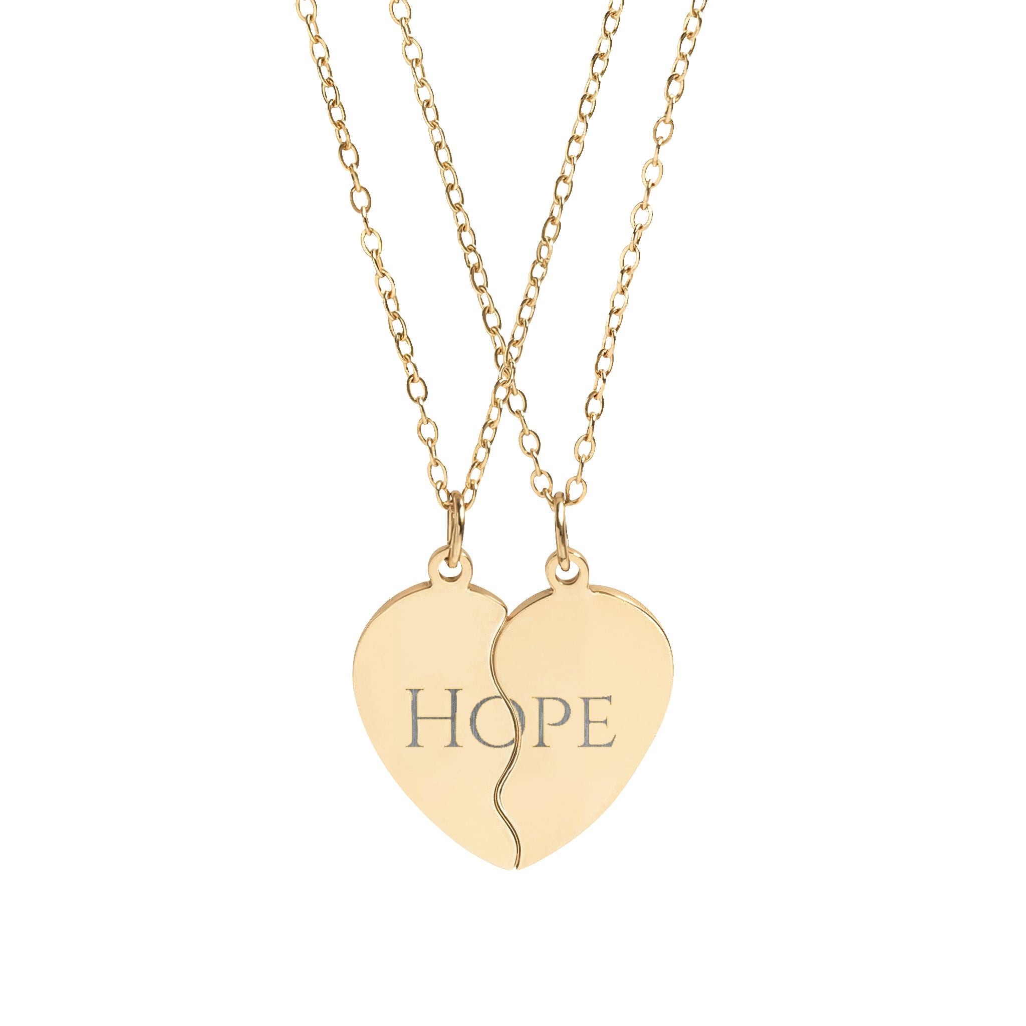 Gold heart-shaped pendant with 'HOPE' engraving on a white background
