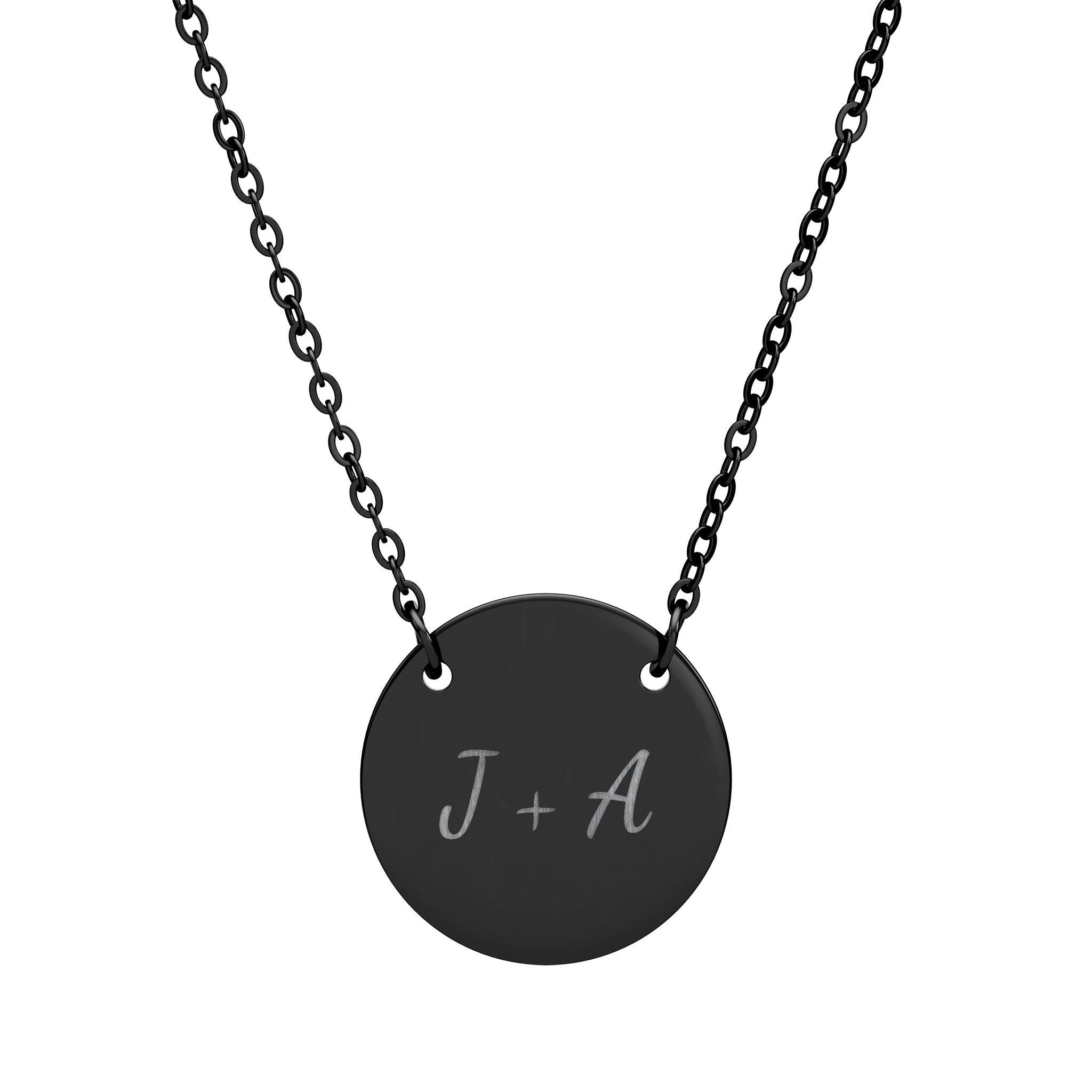 Black necklace with a round pendant featuring 'J + A' on a white background