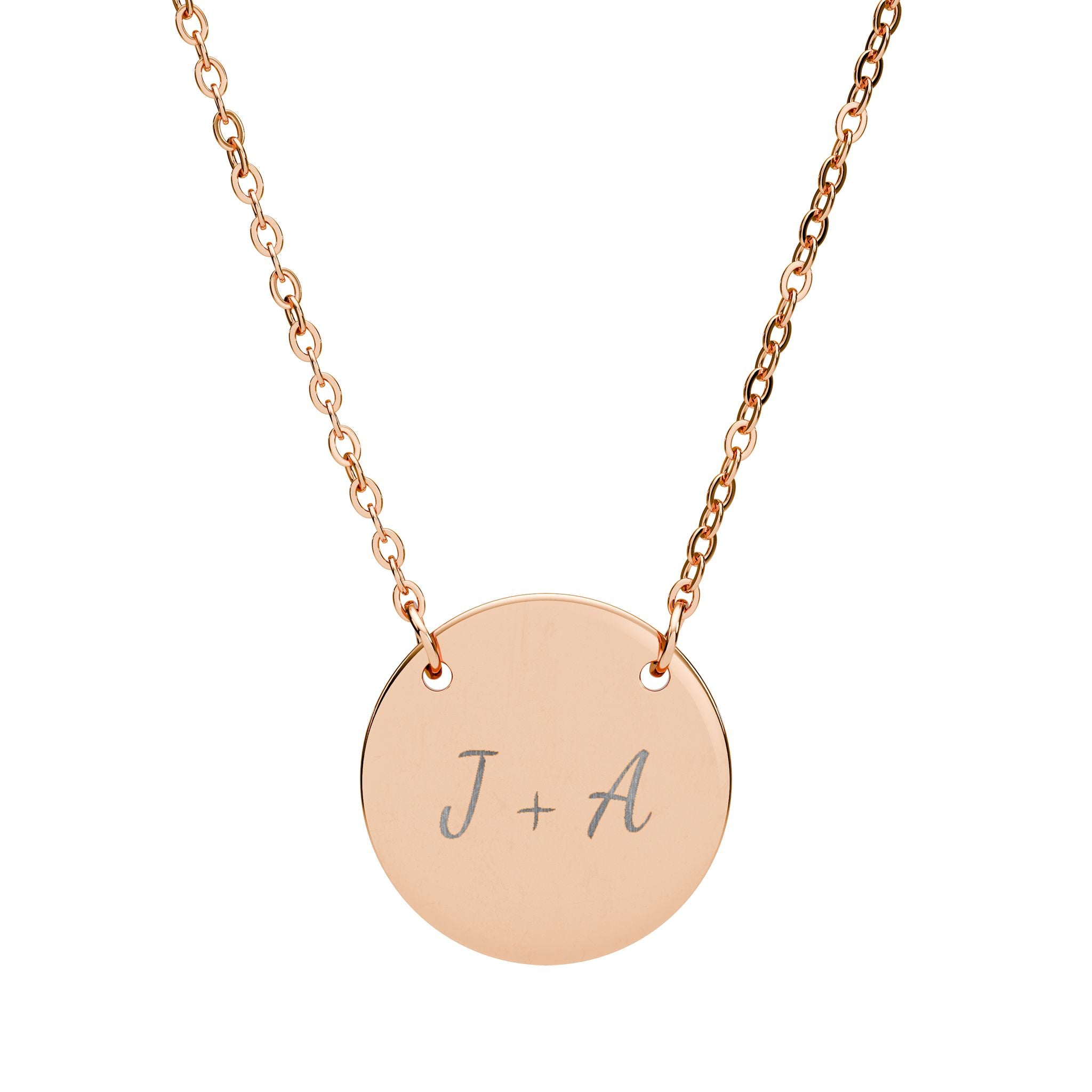 Rose gold necklace with a round pendant engraved with 'J + A' on a white background